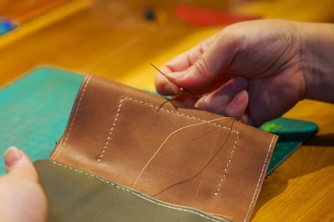 Discover Leather Workshops Experience in Old Town Hoi An - Cutting leather with a professional pattern
