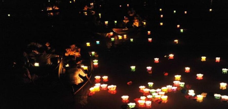 Paper lanterns floating on the Hoai river after dark in Hoi An